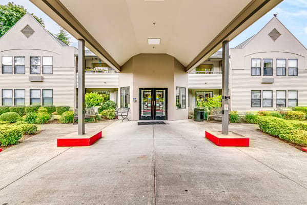 Front entrance of the assisted living facility with outdoor seating