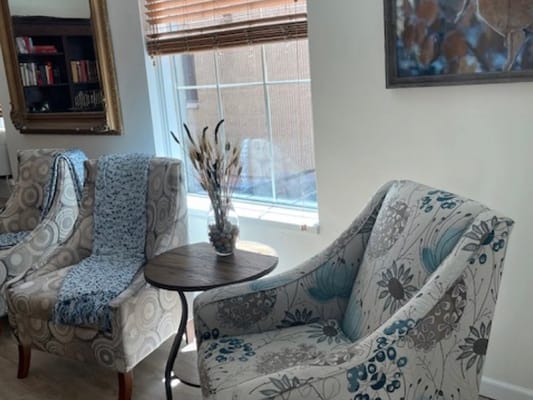 Cozy common area with patterned chairs and a small table