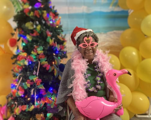 Resident celebrating in a festive indoor setting