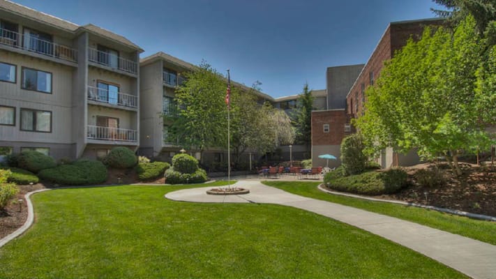 Well-maintained garden with walking paths and seating areas