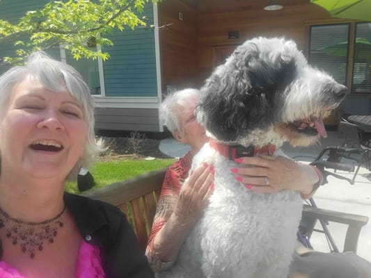 Residents enjoying time outdoors with a dog