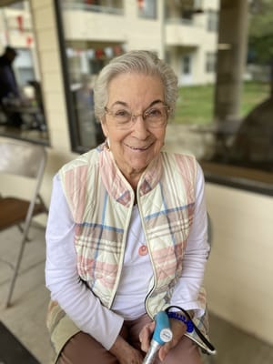 A smiling senior woman sitting indoors