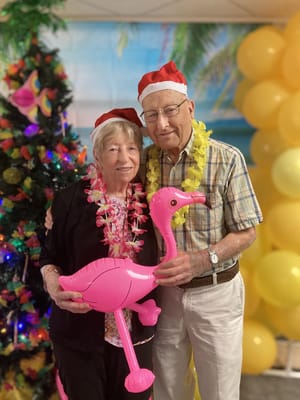 Residents celebrating with hats and tropical decorations