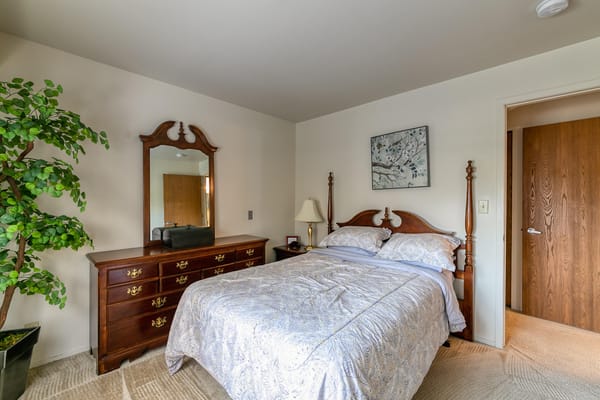 Cozy private resident room with a bed and mirror