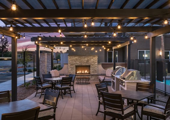 Outdoor seating area with fireplace and grill