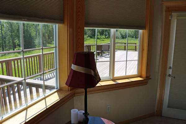 Bright interior view with windows overlooking a deck