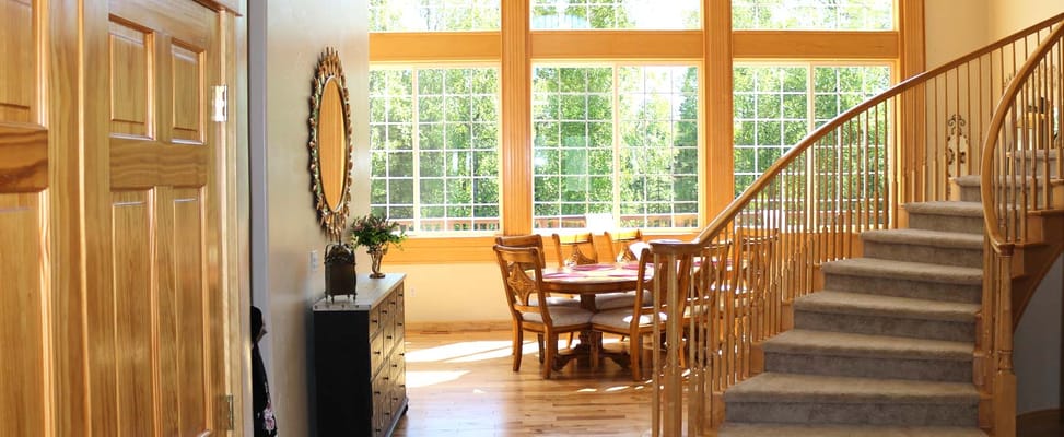 Welcoming common area with large windows and a staircase