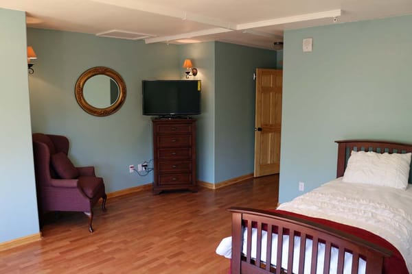 Bright, well-furnished resident room with TV