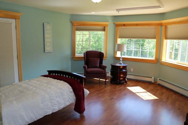 Bright resident room with bed and seating area