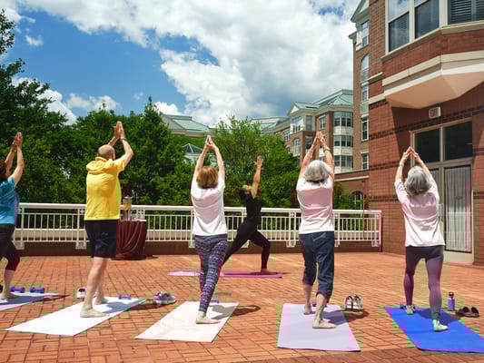 Residents participating in an outdoor yoga class