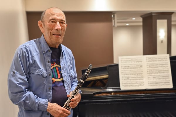 A resident playing the clarinet in a common area
