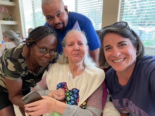 Residents and staff celebrating together in a cheerful setting