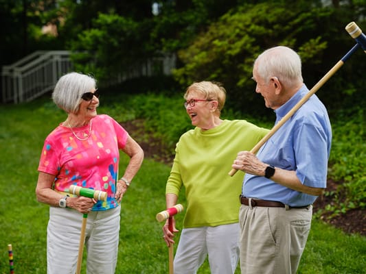 Seniors enjoying a game of croquet outdoors