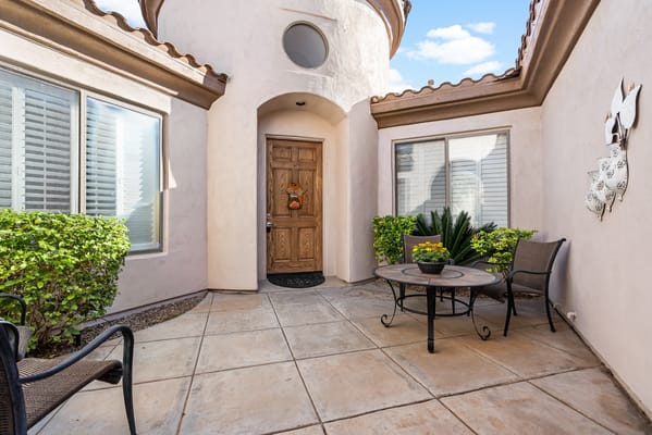 Outdoor seating area with a small table and chairs