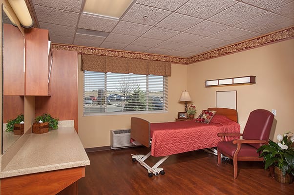 Clean and cozy resident room with a hospital bed