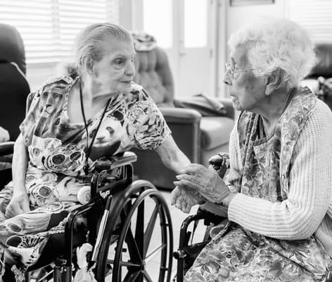 Two residents engaged in conversation in a common area