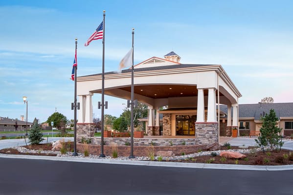 Front entrance of Life Care Center of Cheyenne with flags