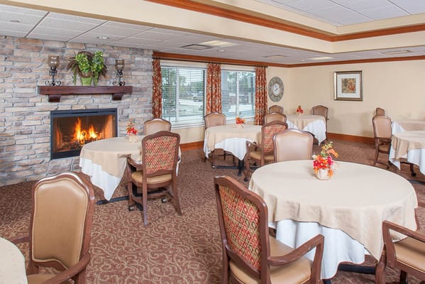 Dining area with tables and a fireplace