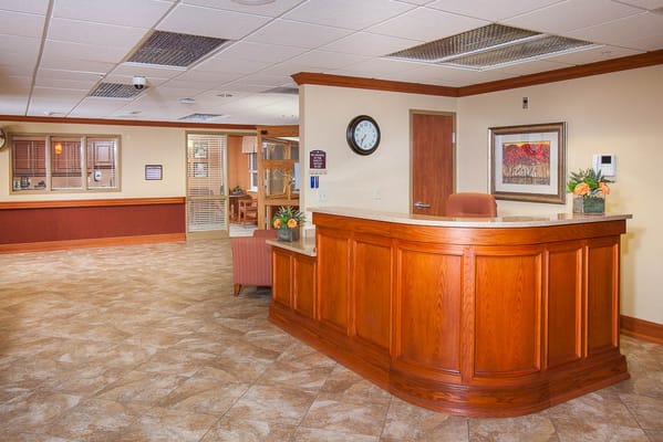 Reception area with wooden front desk in a facility