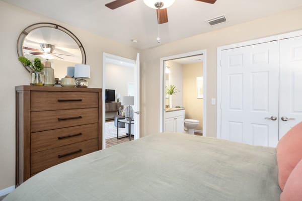 A cozy resident room with a dresser and bathroom
