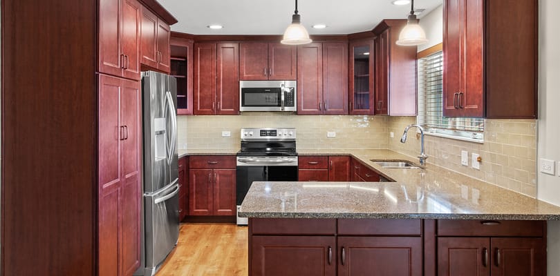 Modern kitchen area with wood cabinets and appliances