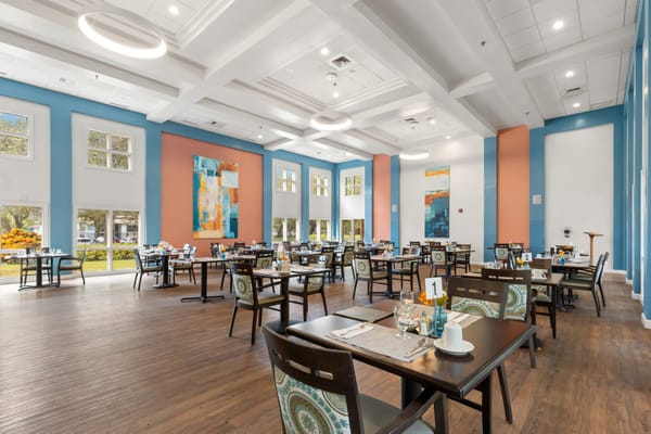 Bright dining room with tables set for meals