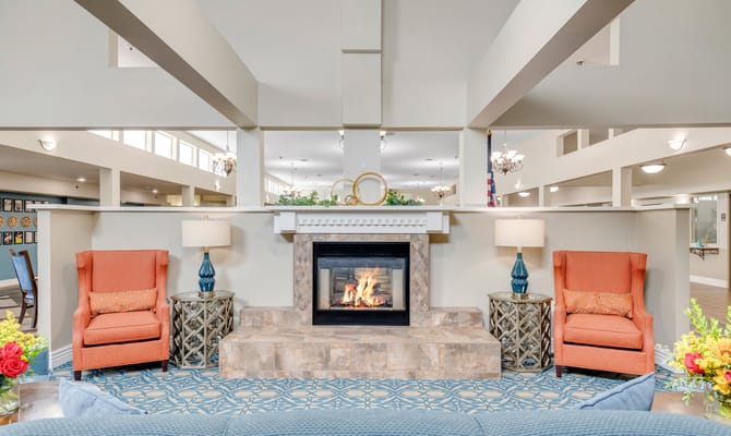 Cozy common area with chairs and a fireplace