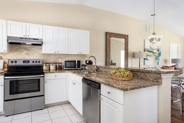 Modern kitchen with stainless steel appliances and granite countertops
