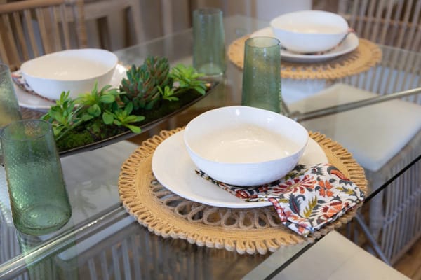 Dining table set with bowls and glasses in an inviting dining area