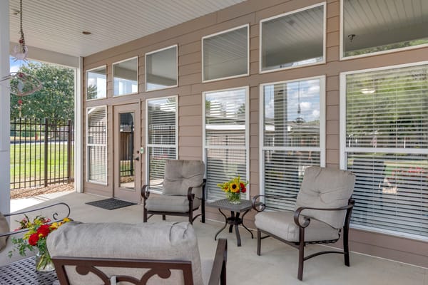Outdoor seating area with flowers and sunlight