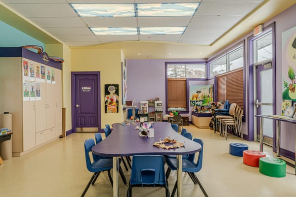 Bright activity room with colorful decor and a large table