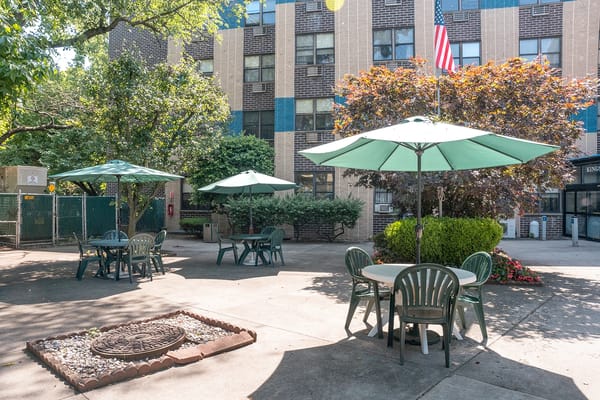 Outdoor seating area with tables and umbrellas at the facility