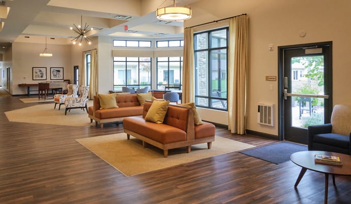 Bright common area with seating and large windows