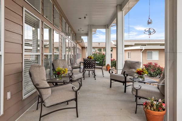 Outdoor seating area with flowers and chairs