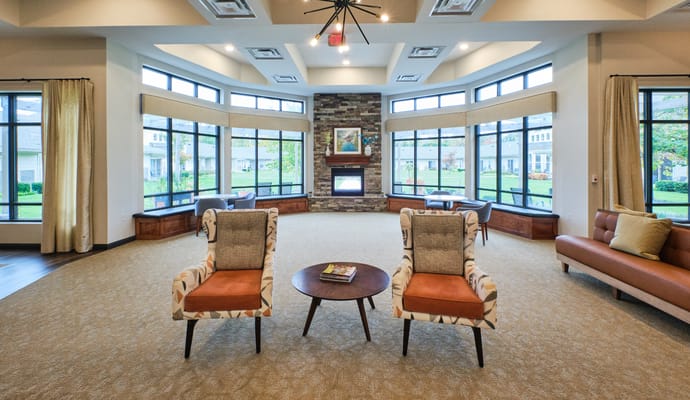 Bright common area with seating and large windows