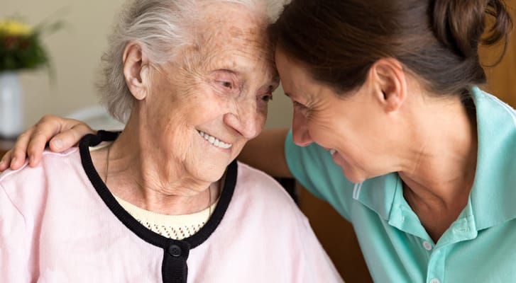 A caregiver and resident sharing a joyful moment