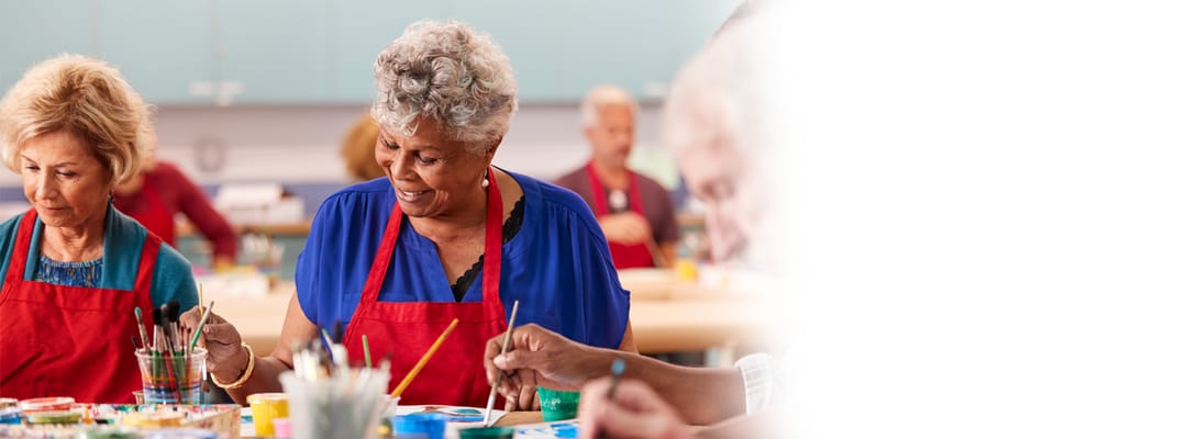 Residents participating in an art activity indoors