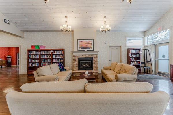 Cozy common area with seating and bookshelves