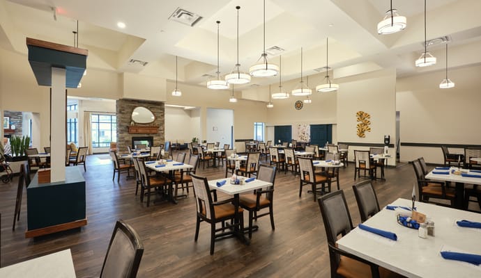 Bright dining room with tables set for meals