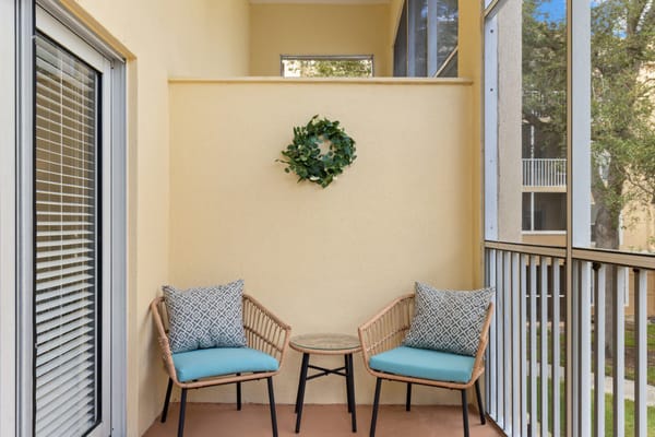 Cozy balcony seating area with decorative wreath
