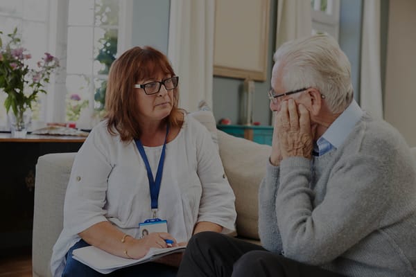 Care staff engaged in conversation with a resident