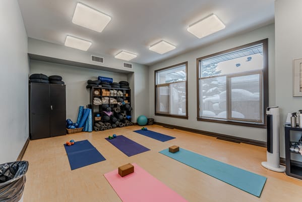 Interior activity room with yoga mats and exercise equipment