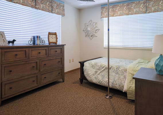 A private resident room with a bed and furniture