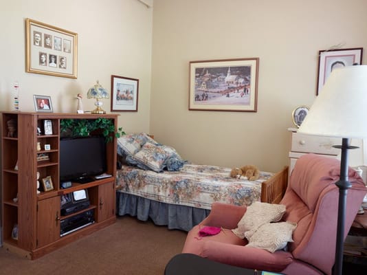 Cozy resident room with bed and furniture