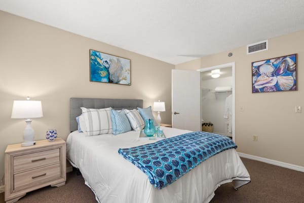 A well-decorated private resident room with a bed and art