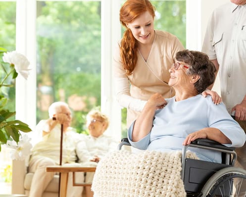 Staff assisting a resident in a common area