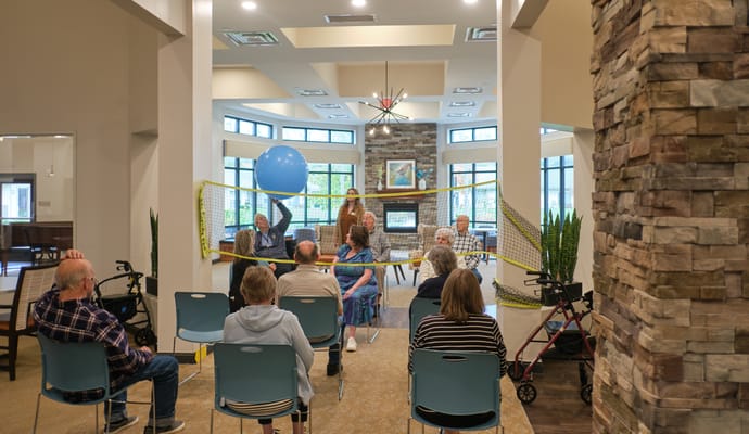Residents participating in a game activity indoors