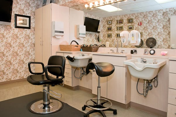 Hair salon area with styling chairs and sinks