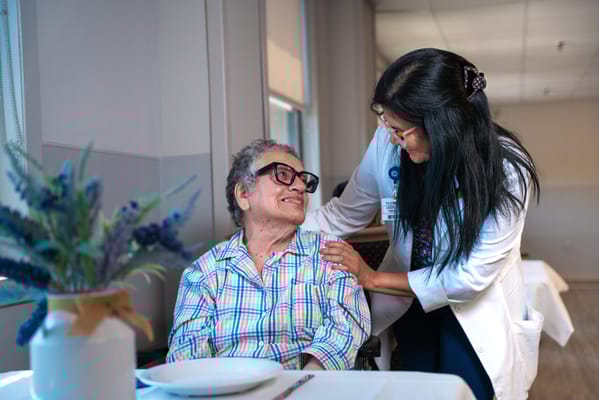 A caregiver interacting joyfully with a resident in a facility