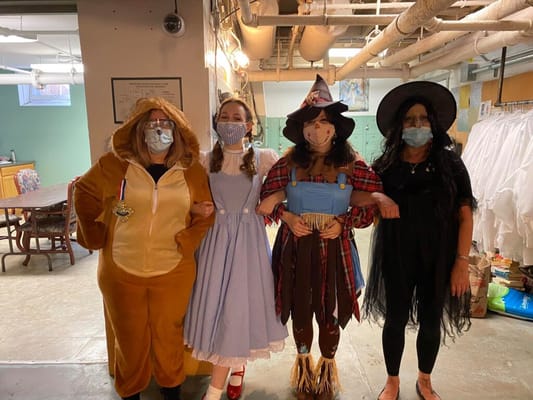 Staff and residents dressed in costumes for a themed event